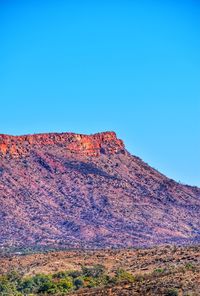 Scenic view of mountain against blue sky