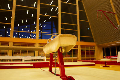 Side view of man on table against illuminated building