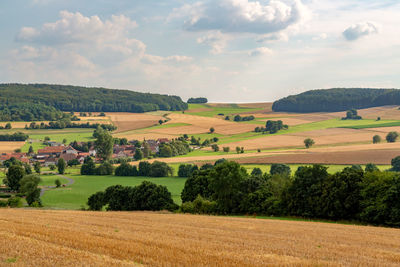 Scenic view of agricultural field against sky