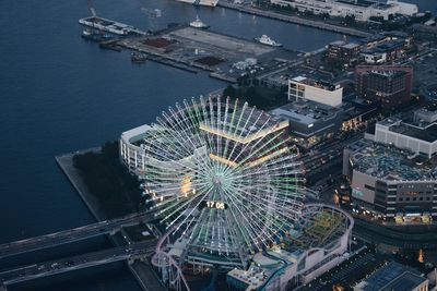 High angle view of illuminated ferris wheel in city