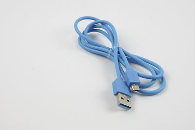 Close-up of blue usb cable over white background