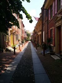 Narrow alley amidst houses and buildings in city