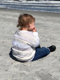 Side view of boy standing at beach