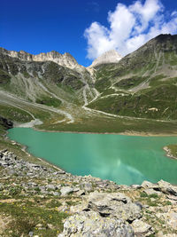 Scenic view of lake and mountains against blue sky