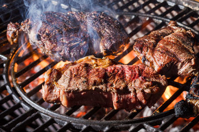 Close-up of meat cooking on barbecue grill