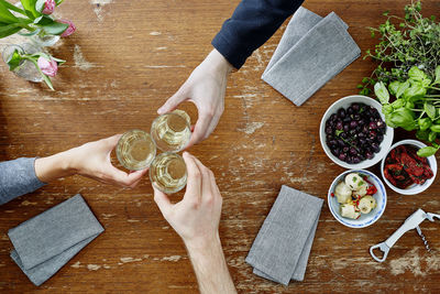 High angle view of woman holding drink on table