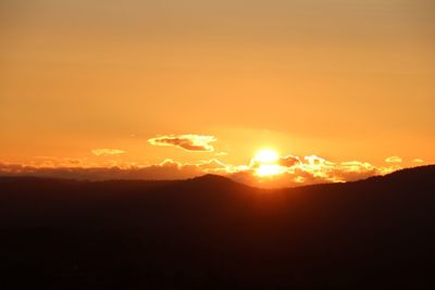 Scenic view of silhouette mountains against sky during sunset