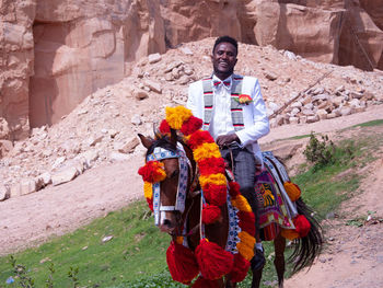 Portrait of young man riding horse