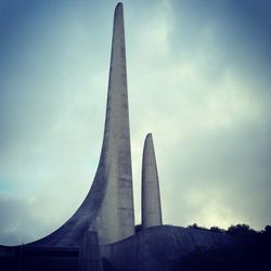 Low angle view of monument against cloudy sky