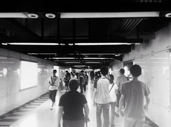 People in illuminated underground at night