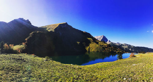 Scenic view of mountains against blue sky