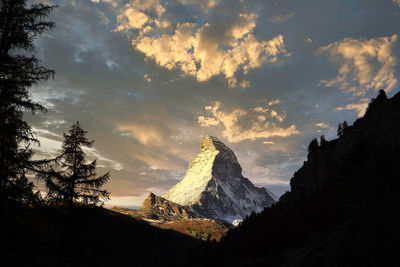 Panoramic view of snowcapped mountains against sky during sunset