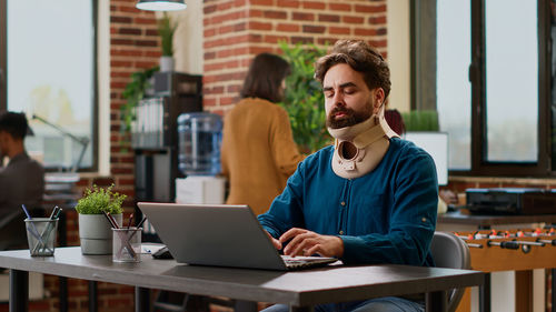 Young woman using laptop on table