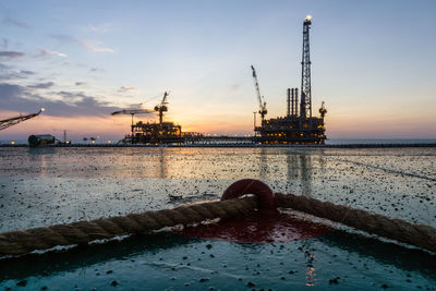 Sunset at oilfield viewed from a helipad of a construction barge