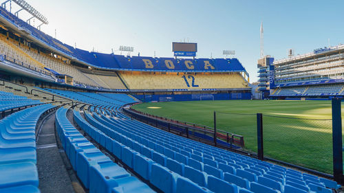 High angle view of soccer field against blue sky