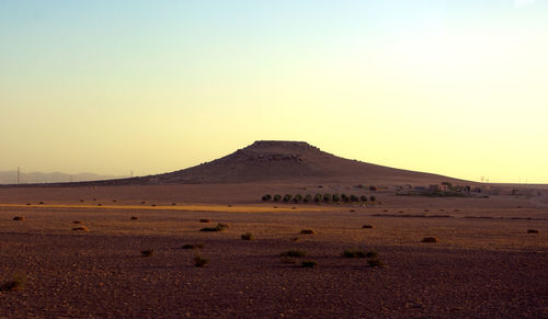 Scenic view of arid landscape against clear sky