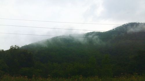 Scenic view of mountains against cloudy sky