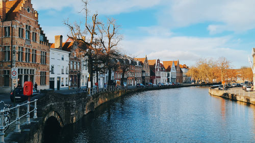 Canal amidst buildings in background