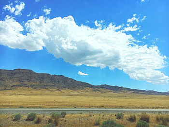 Scenic view of mountains against blue sky