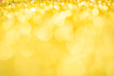 Defocused image of illuminated yellow background