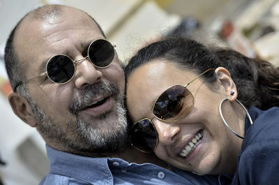 Portrait of happy couple wearing sunglasses