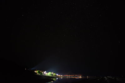 Illuminated city against sky at night