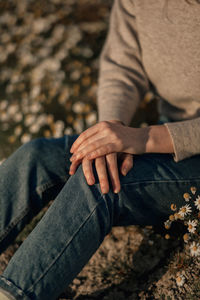 Midsection of couple holding hands