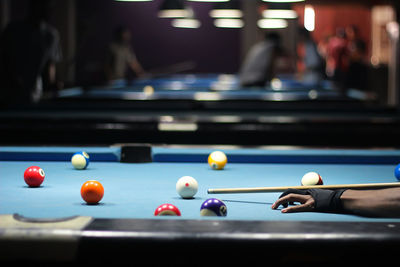 Cropped hand of man playing snooker