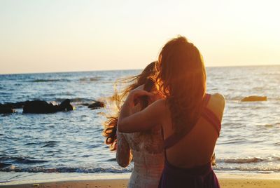 Women standing on beach