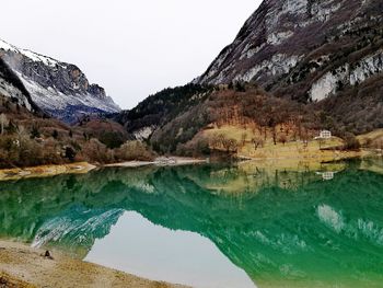 Scenic view of lake and mountains against sky