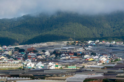 High angle view of buildings in city against sky