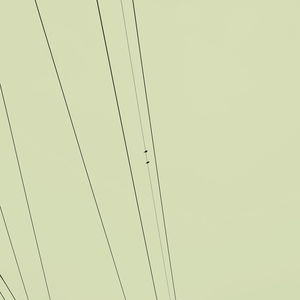 Low angle view of power lines against clear sky