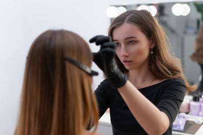 Artist applying make-up on woman 