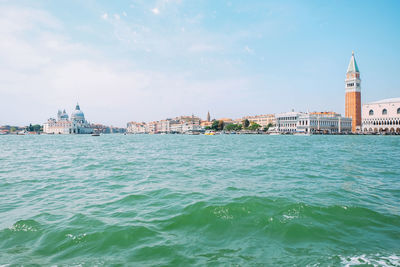 View of sea and buildings against sky