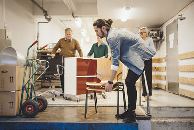 Multi-ethnic business people with equipment moving into new office