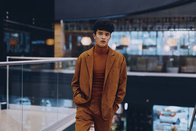 Portrait of young man standing in supermarket