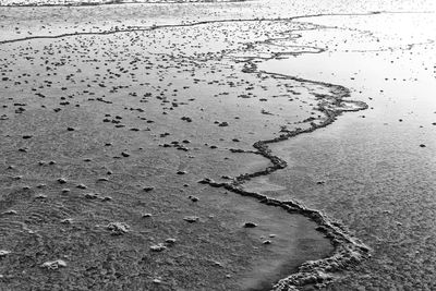 High angle view of wet sand on beach