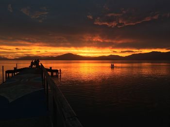 Silhouette pier on sea against sky during sunset