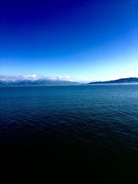 Scenic view of sea against blue sky