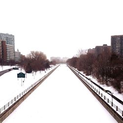 Snow covered walkway in city