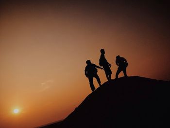 Silhouette of hikers on hill