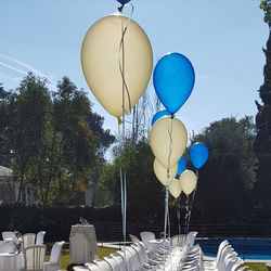 Balloons on table against clear sky