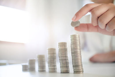 Cropped image of hand holding stack of coin