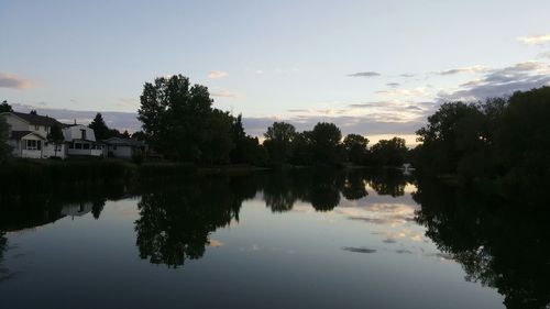 Calm lake with buildings in background