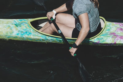 Low section of woman sitting in kayak