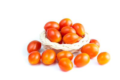 Close-up of tomatoes over white background