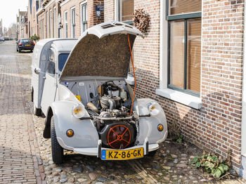 Cars on street against building