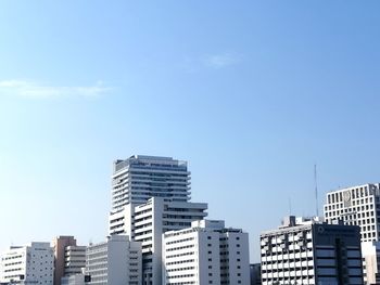 Low angle view of buildings against clear blue sky