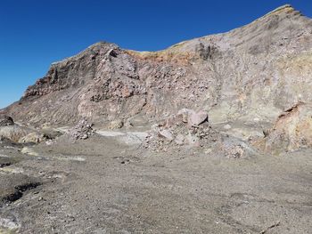 Scenic view of rocky mountains against clear blue sky