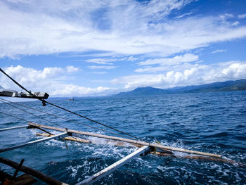 Sailboat sailing in sea against sky